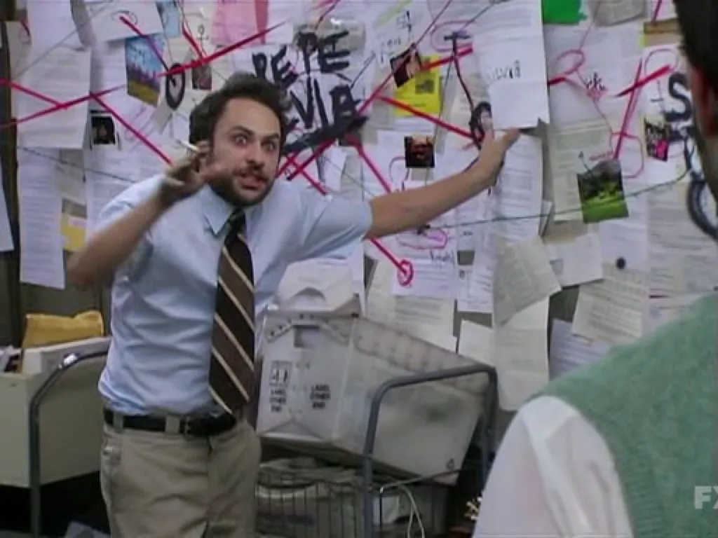 The classic conspiracy theory meme of Charlie from Always Sunny in Philidelphia in front of a board with papers and red string